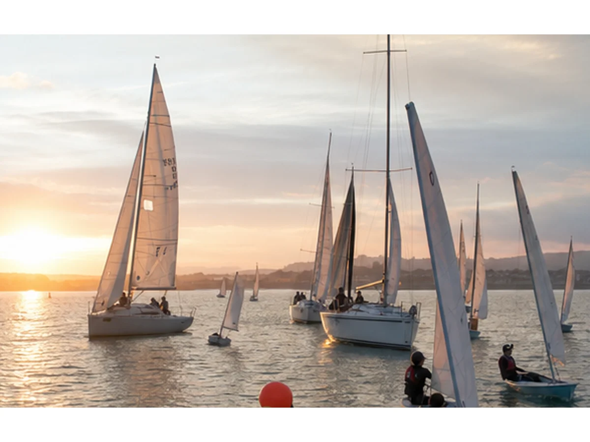 Sailing club evening racing on the harbour at sunset